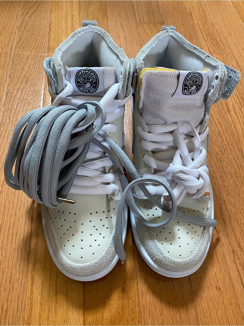 Nike High-Top SB Dunk Sneakers in White and Light Gray with Yellow Tongue Accent